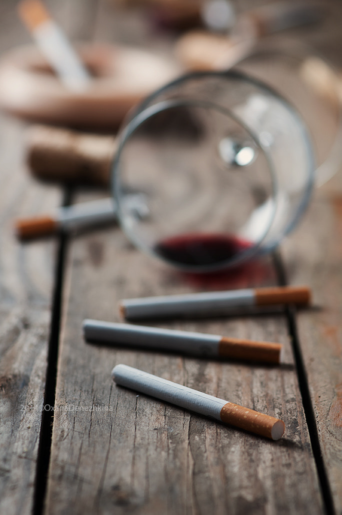 Cigarette and wine on the wooden table