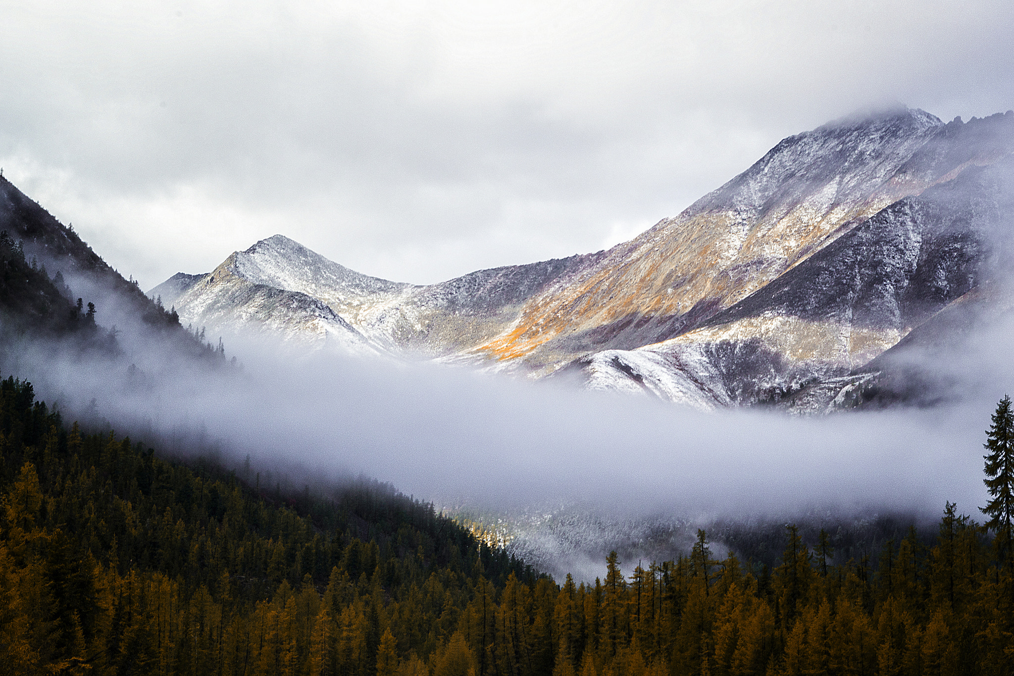 With high mountains down the fog ...